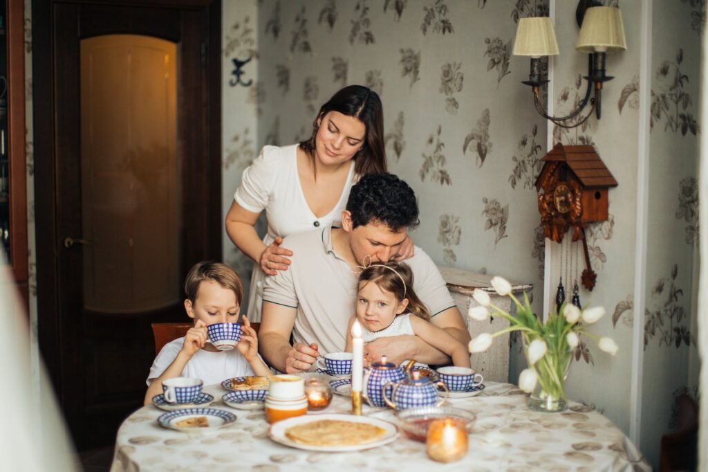 a happy family drinking tea at home